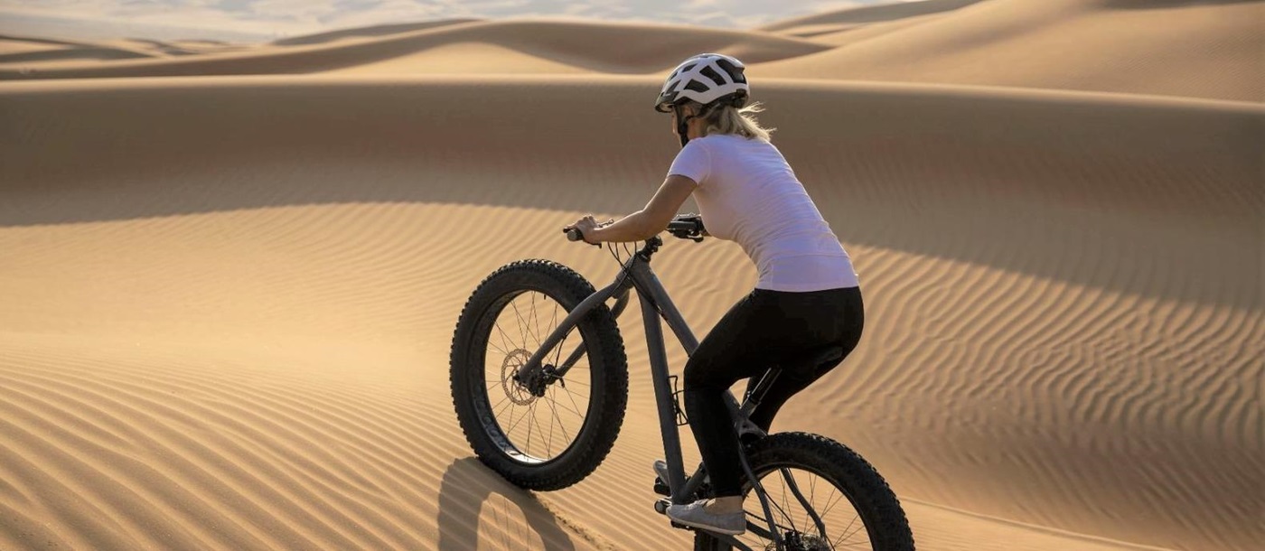 Fat biking in the Liwa Desert near Qasr Al Sarab Desert Resort in the United Arab Emirates