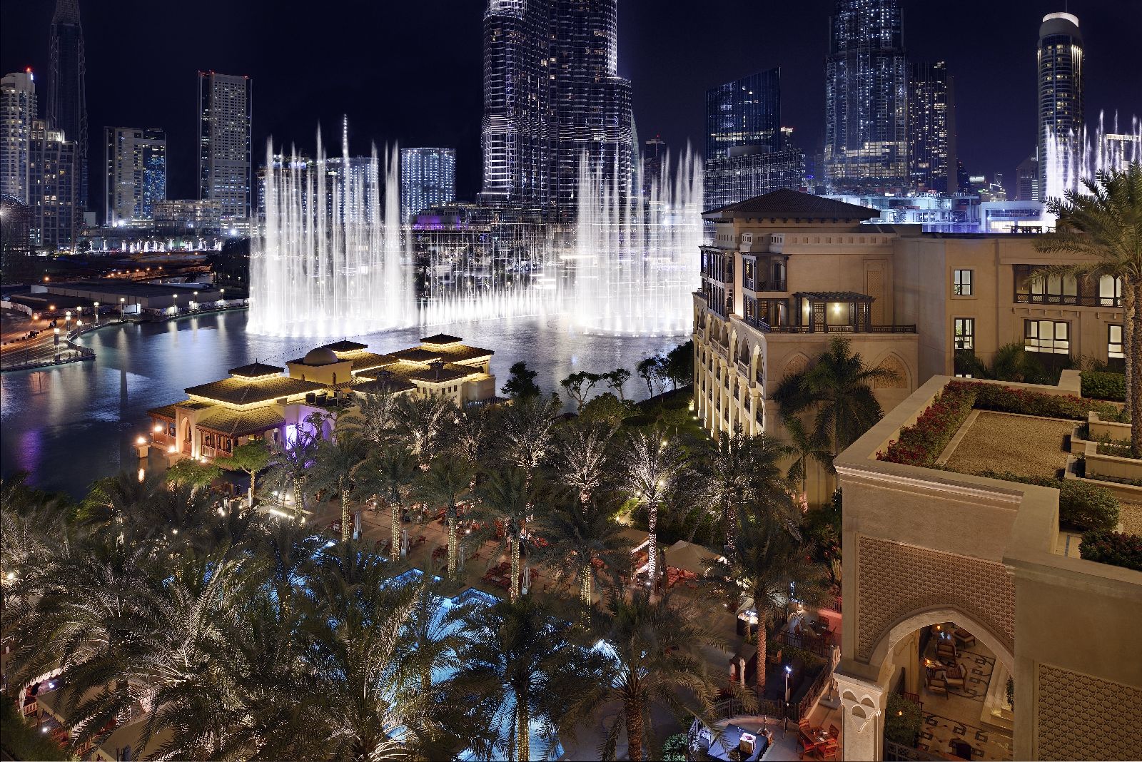 Aerial view of the Palace Downtown and Dubai fountains by night