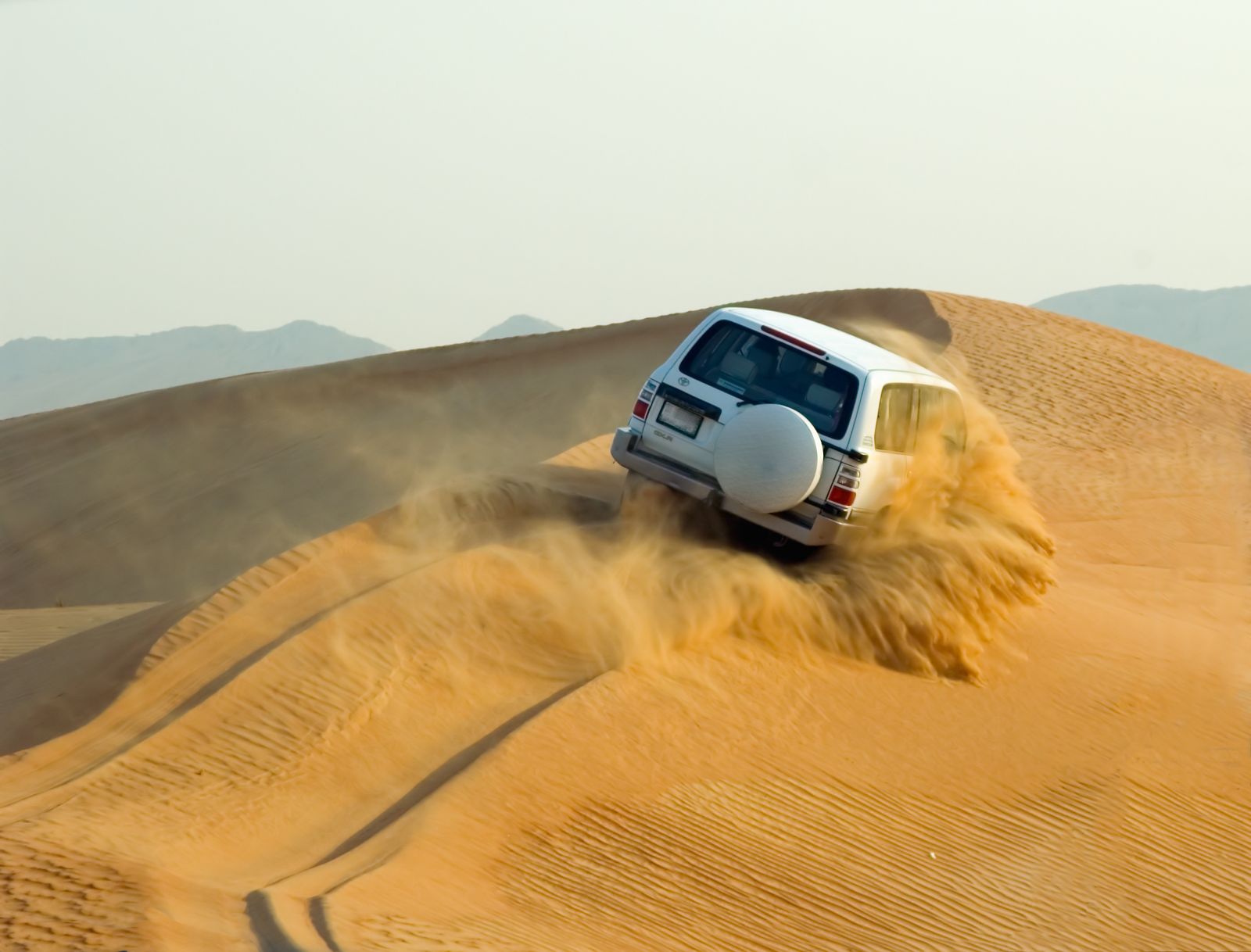 Four wheel drive vehicle dune bashing in the Dubai desert