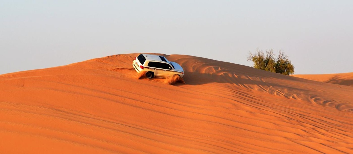 Aerial view of a 4x4 dune bashing in the Abu Dhabi desert