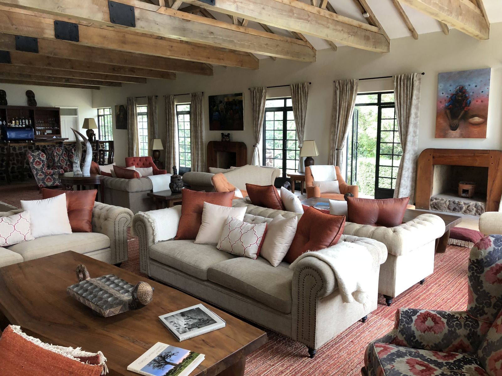 The living area with sofas, chairs and tables at the main building at Clouds Mountain Gorilla Lodge in Uganda