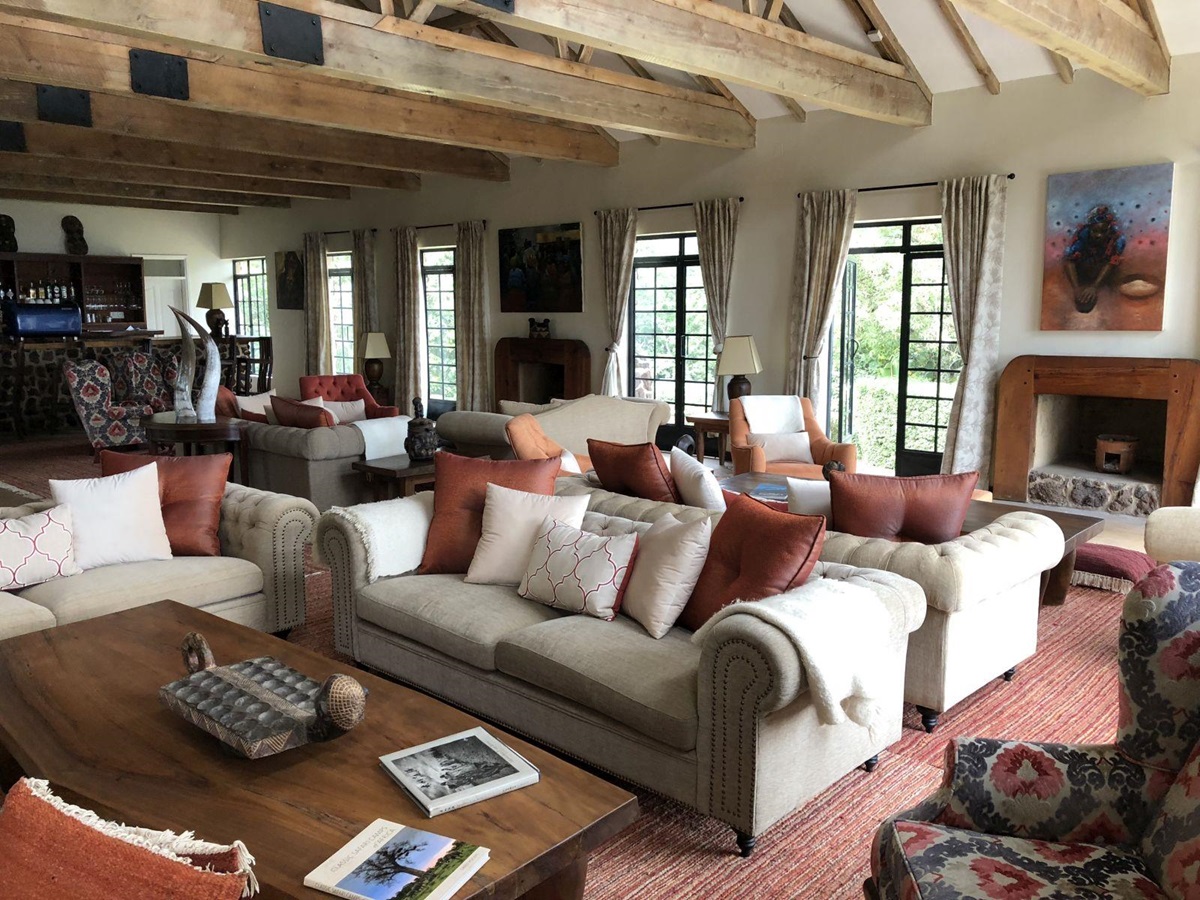 The living area with sofas, chairs and tables at the main building at Clouds Mountain Gorilla Lodge in Uganda