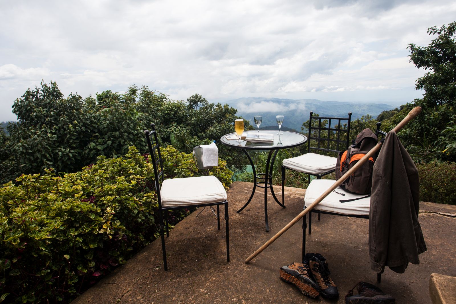 The terrace with a table and two chairs at Clouds Mountain Gorilla Lodge in Uganda