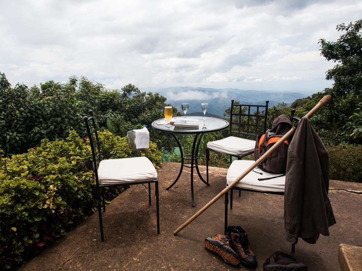 The terrace with a table and two chairs at Clouds Mountain Gorilla Lodge in Uganda