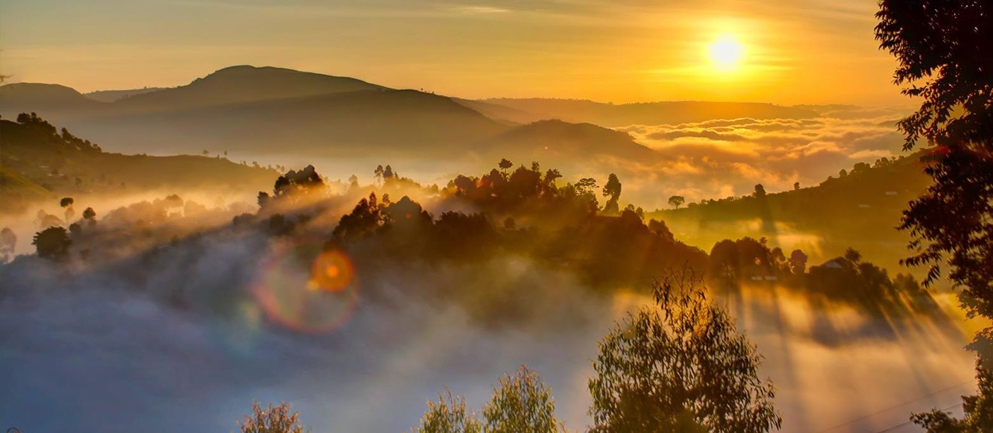 Sun rising over the misty hills of the highlands in Uganda