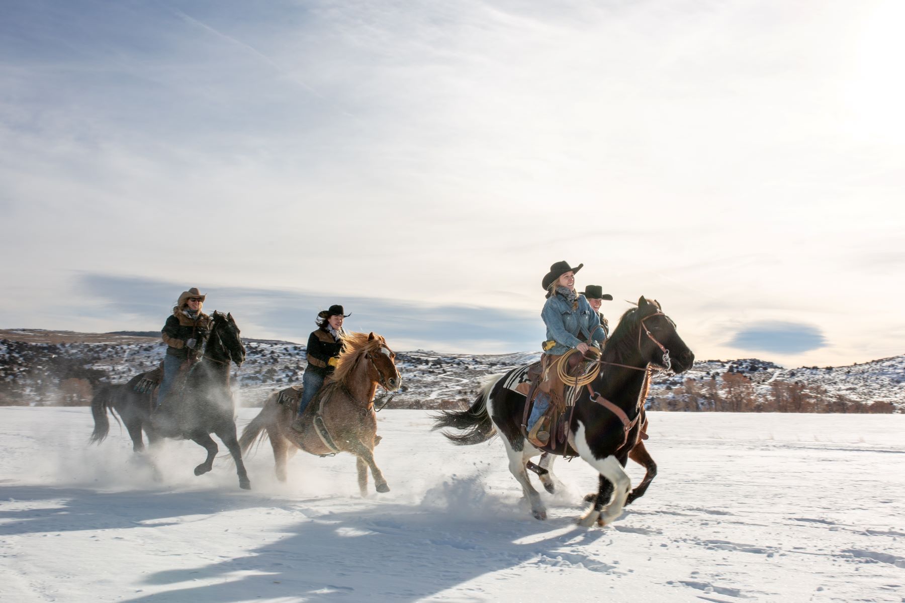 Guests of Brush Creek Ranch & Spa riding through the snow in Wyoming