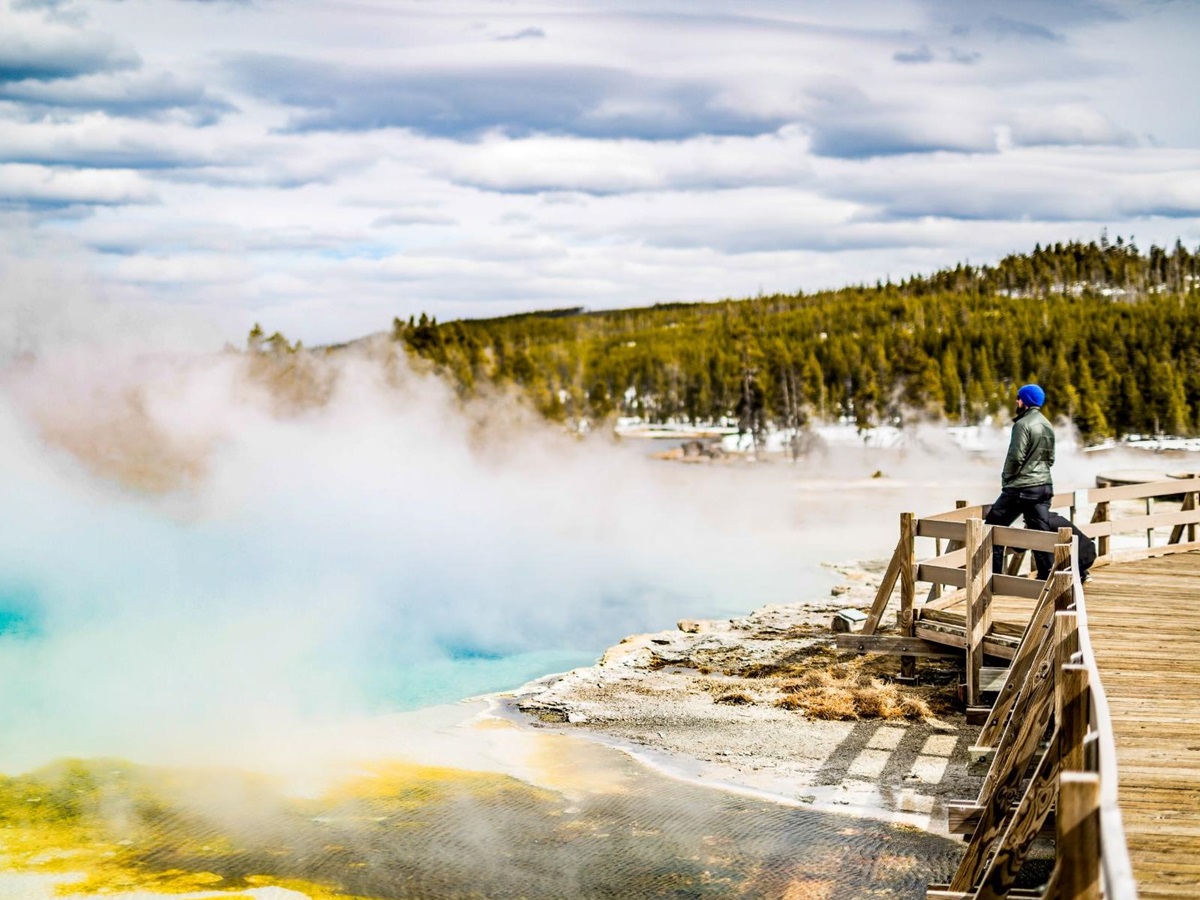 A guest of Lone Mountain Ranch admiring the hot springs