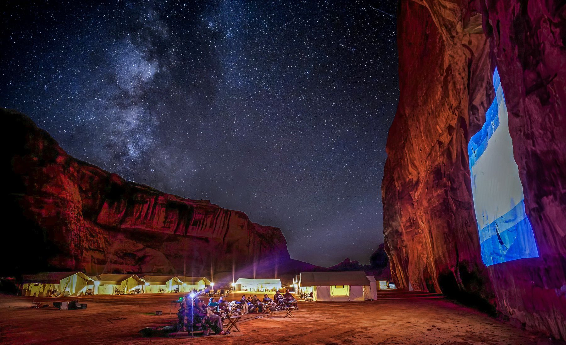 Movie projected onto a cliff in Monument Valley as part of EXP Journeys private camps