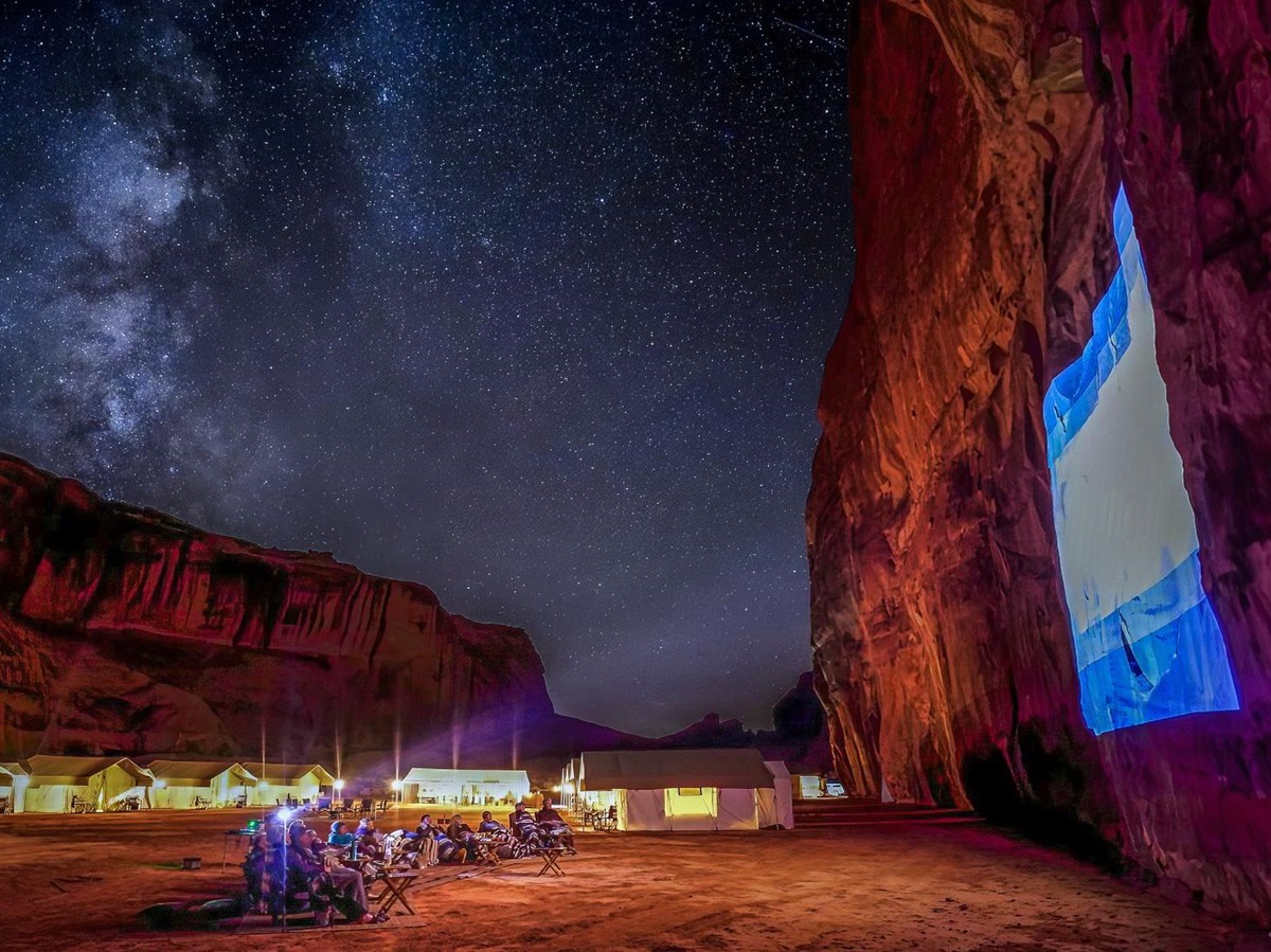 Movie projected onto a cliff in Monument Valley as part of EXP Journeys private camps