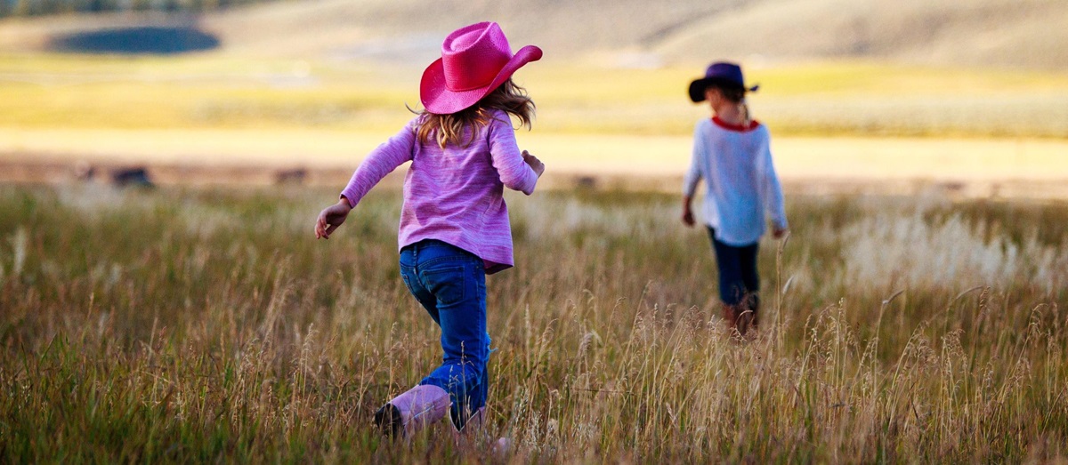 Children playing in the field of Paws Up Ranch, USA