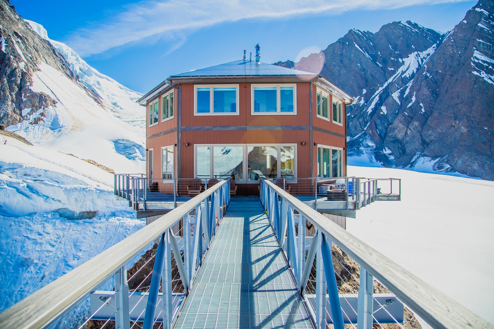 Exterior of chalet with walkway leading to glass door