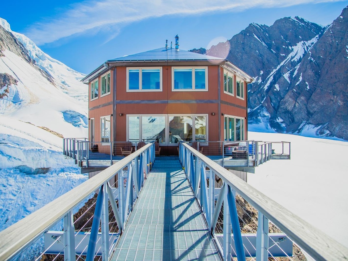 Exterior of chalet with walkway leading to glass door