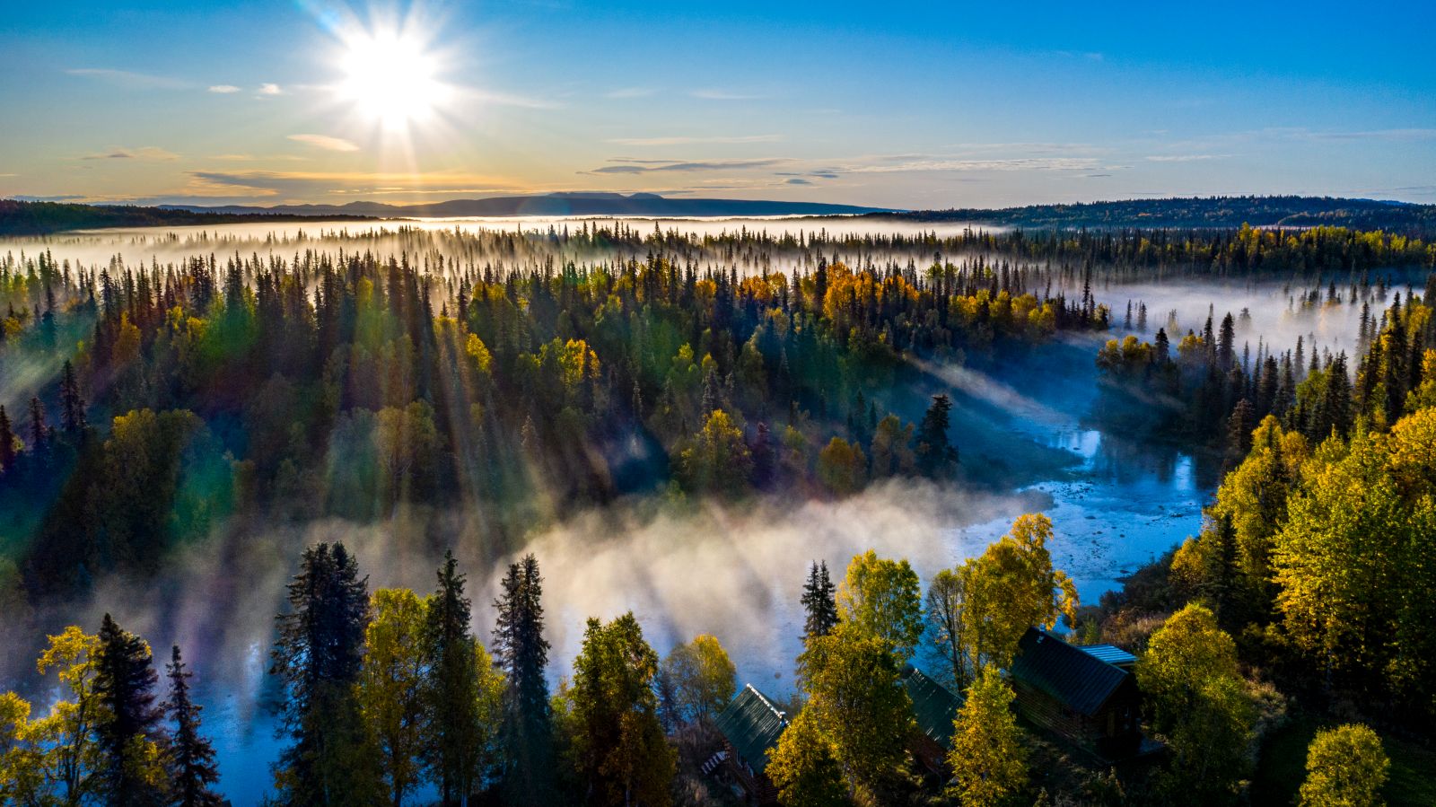 Sunrise over the forest surrounding Tordrillo Mountain Lodge Alaska