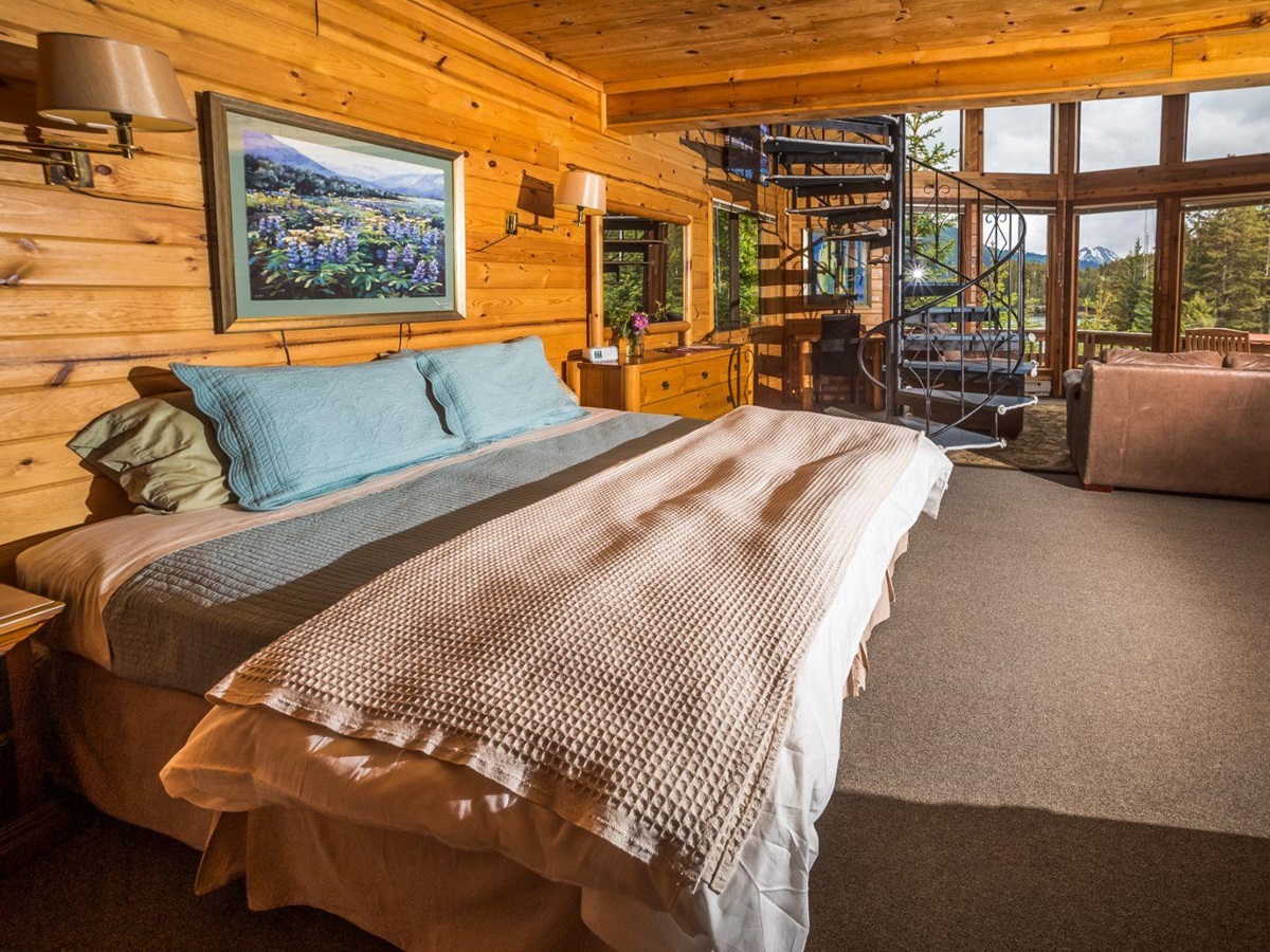 Kittiwake Cabin bed and window view at Tutka Bay Lodge in Alaska, USA