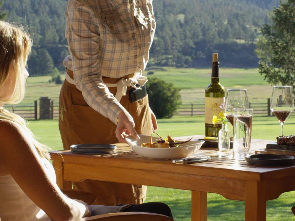 Guests enjoying outdoor dining at Ted Turner's Vermejo reserve in New Mexico USA