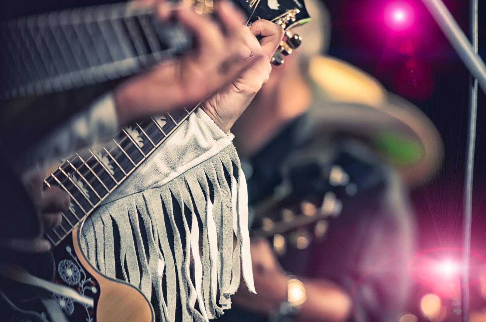 Closeup shot of someone playing a guitar