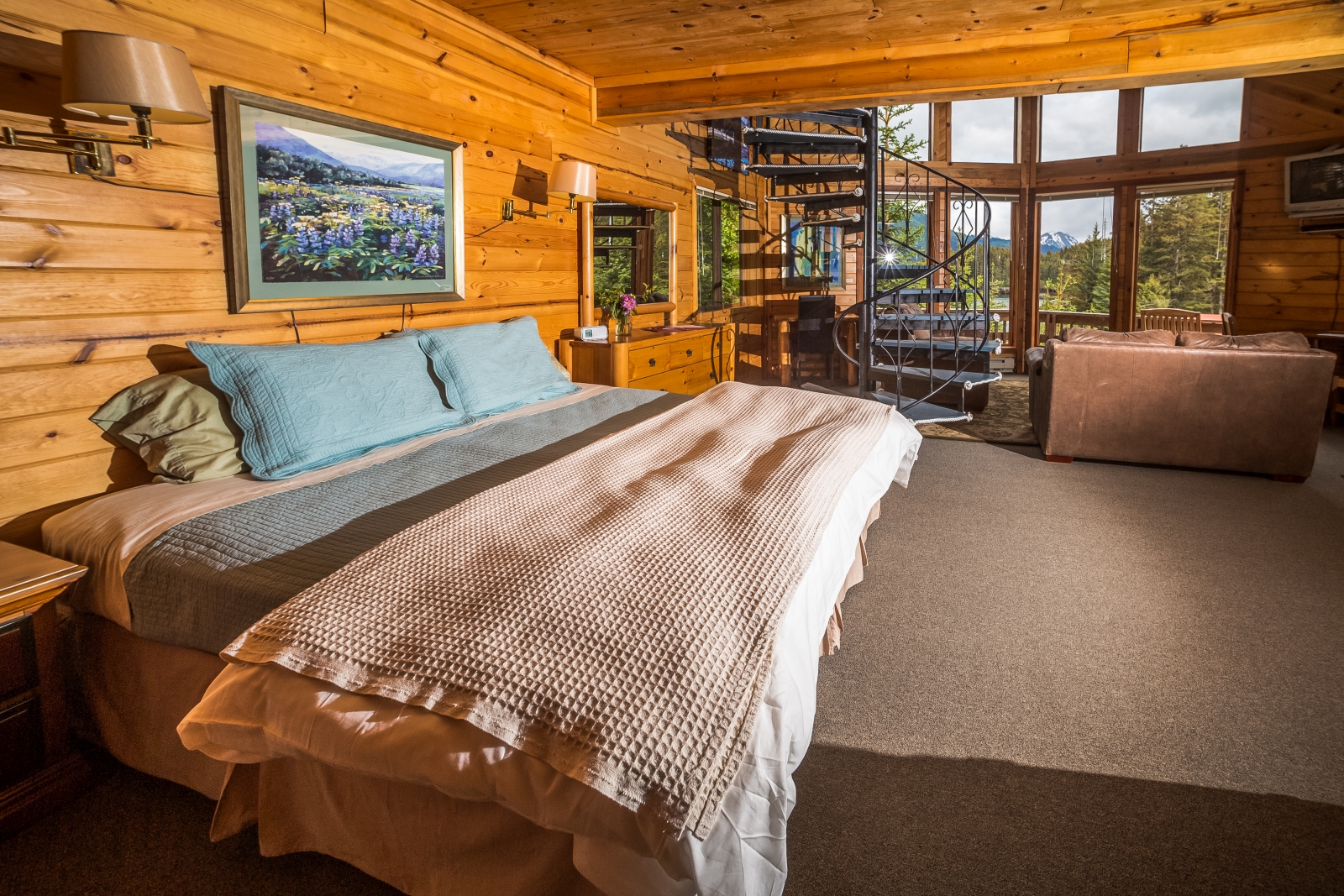 Double bedroom in a wooden cabin with large window