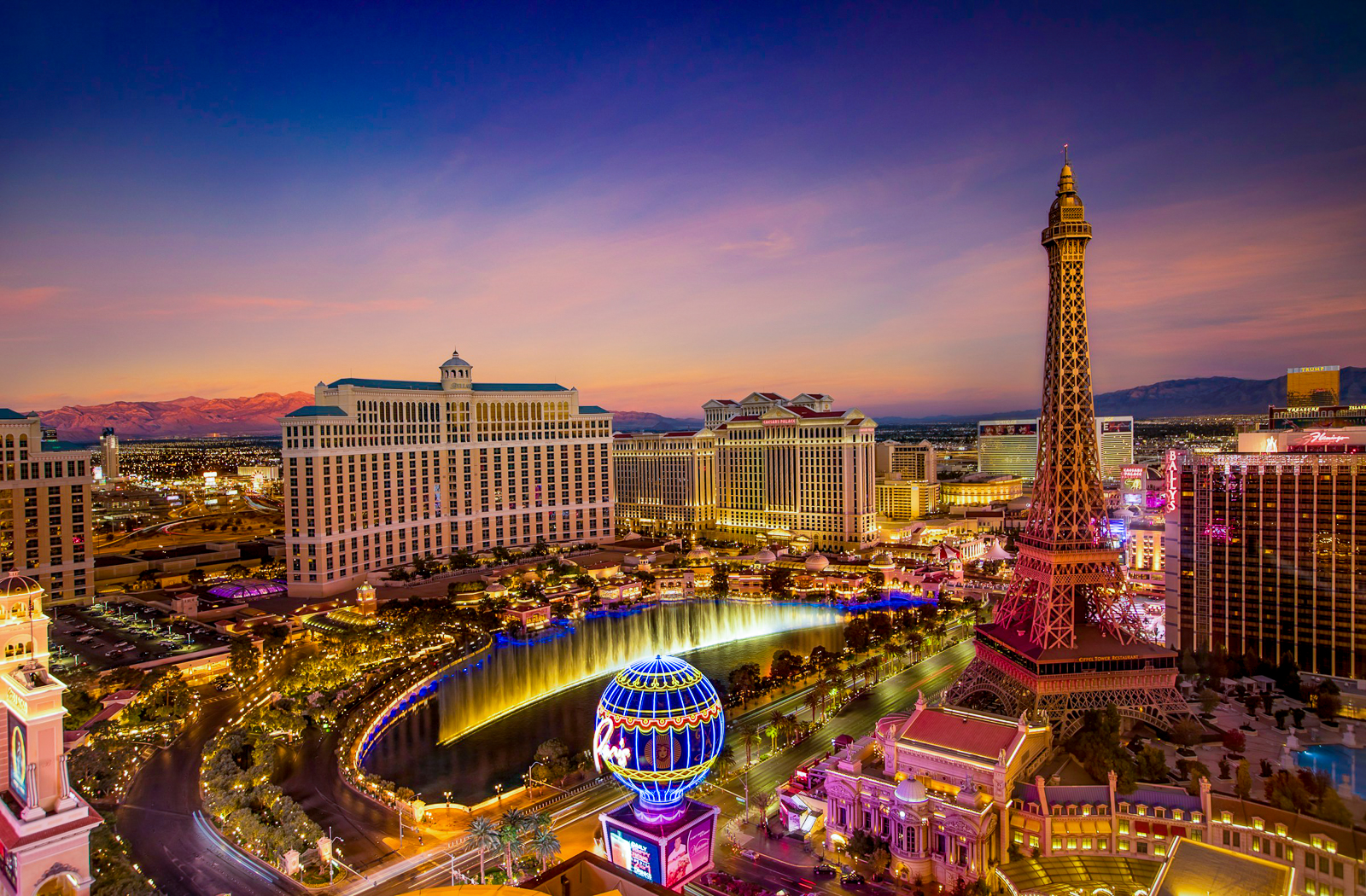 Las Vegas skyline at night featuring the Eiffel Tower and Westgate Hotel