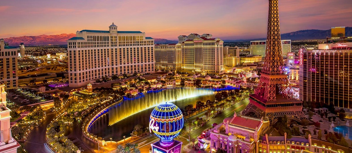 Las Vegas skyline at night featuring the Eiffel Tower and Westgate Hotel