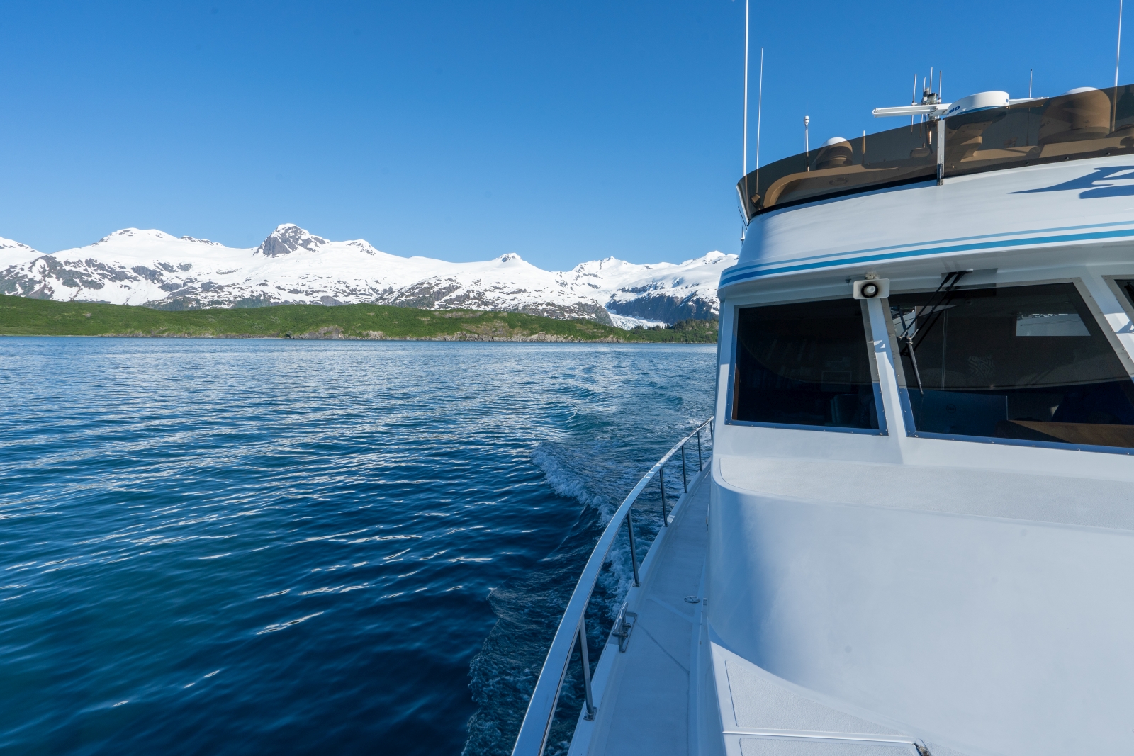 Side of boat with snowy mountains in the background