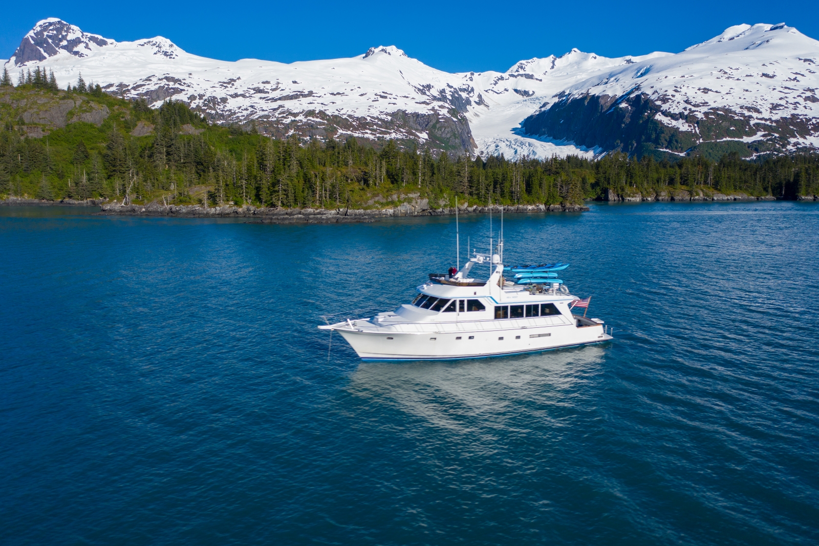 Large boat on a lake with mountains in the background