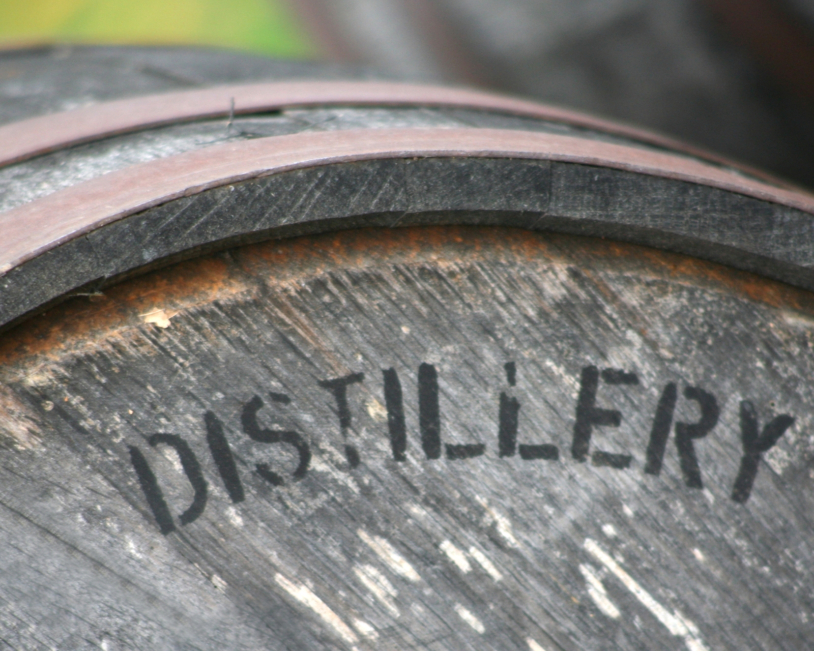 The word 'Distillery' printed on a wooden barrel