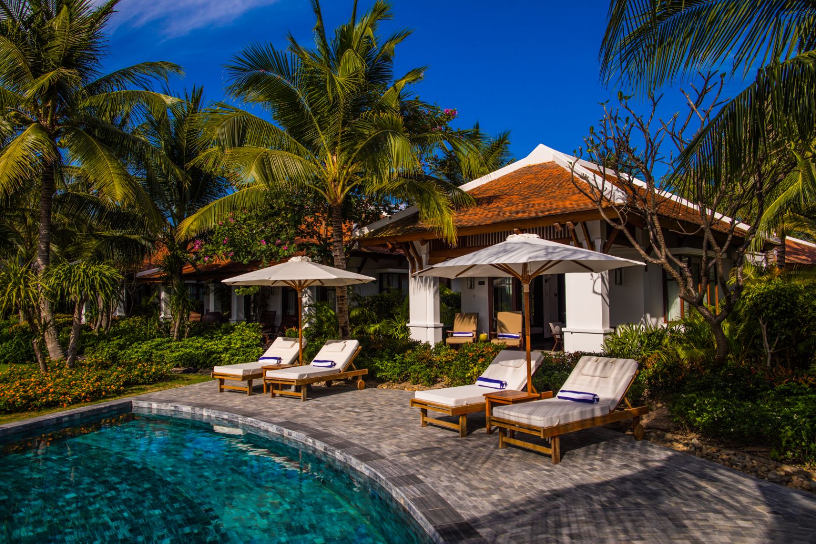 Sunbeds by a private villa pool at The Anam resort in Cam Ranh, Vietnam