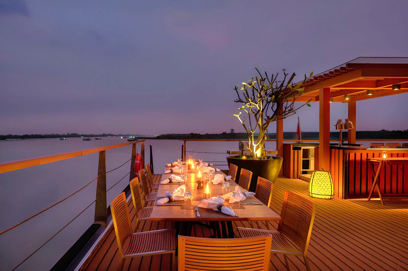 Dining on the upper deck during evening onboard the Aqua Mekong river cruise in Vietnam