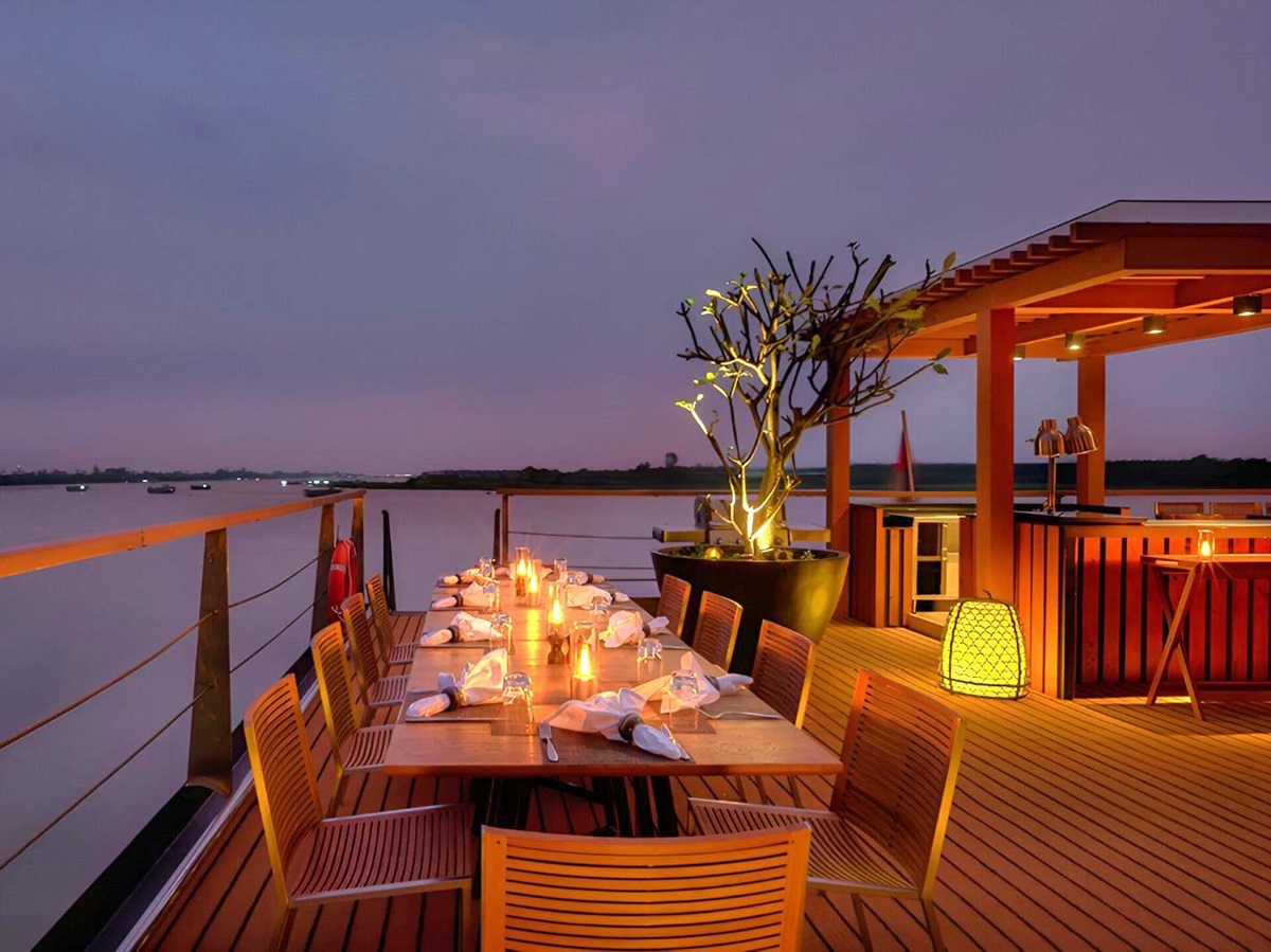 Dining on the upper deck during evening onboard the Aqua Mekong river cruise in Vietnam