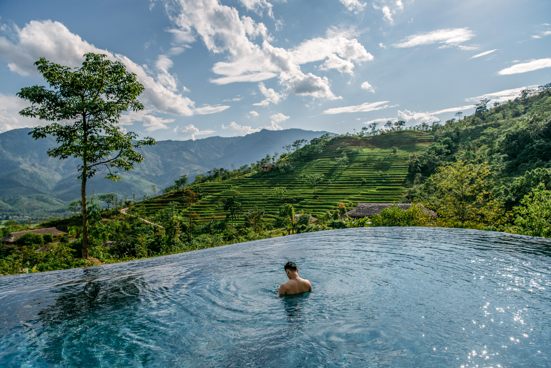 Man in the swimming pool at Avana Retreat in Vietnam