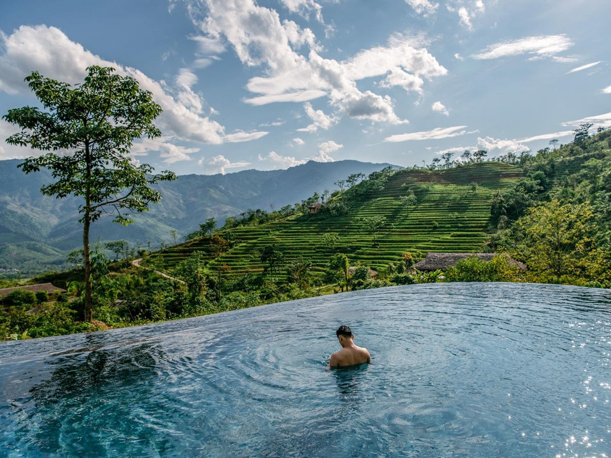 Man in the swimming pool at Avana Retreat in Vietnam