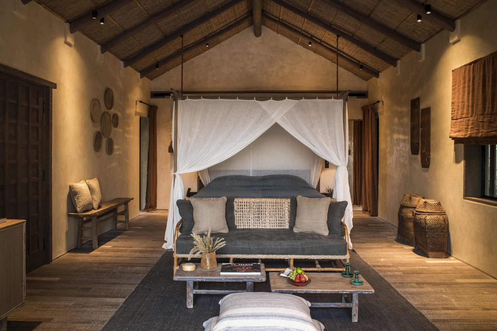 Spacious bedroom with a four poster bed in a Beach Pool Villa at luxury resort Zannier Bai San Ho in Vietnam