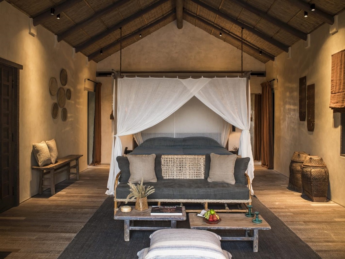 Spacious bedroom with a four poster bed in a Beach Pool Villa at luxury resort Zannier Bai San Ho in Vietnam