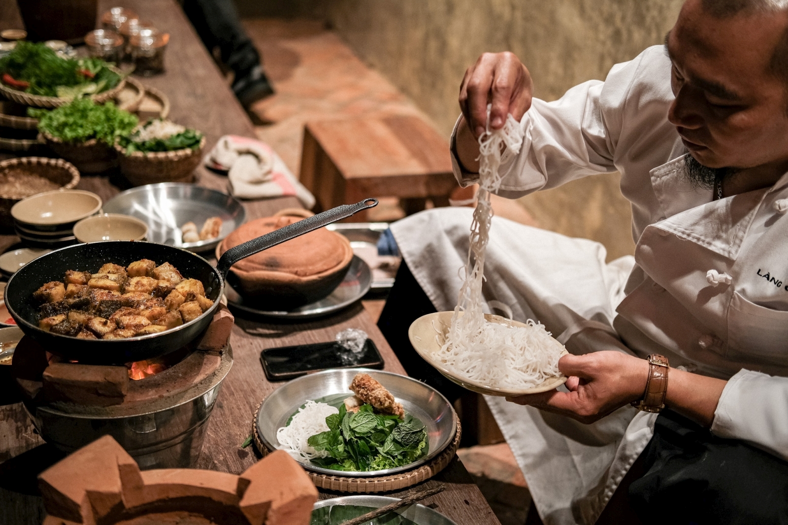 Chef preparing dinner at luxury resort Zannier Bai San Ho in Vietnam