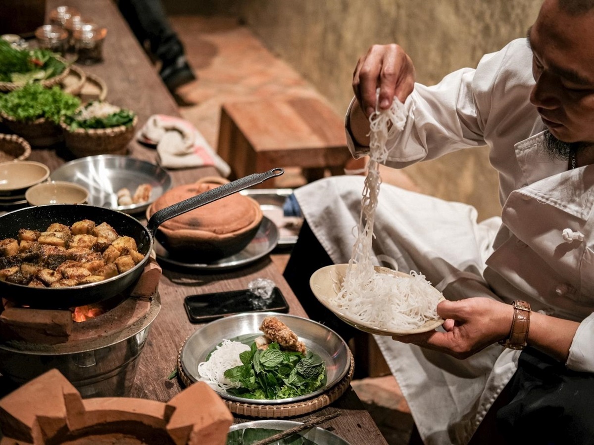 Chef preparing dinner at luxury resort Zannier Bai San Ho in Vietnam
