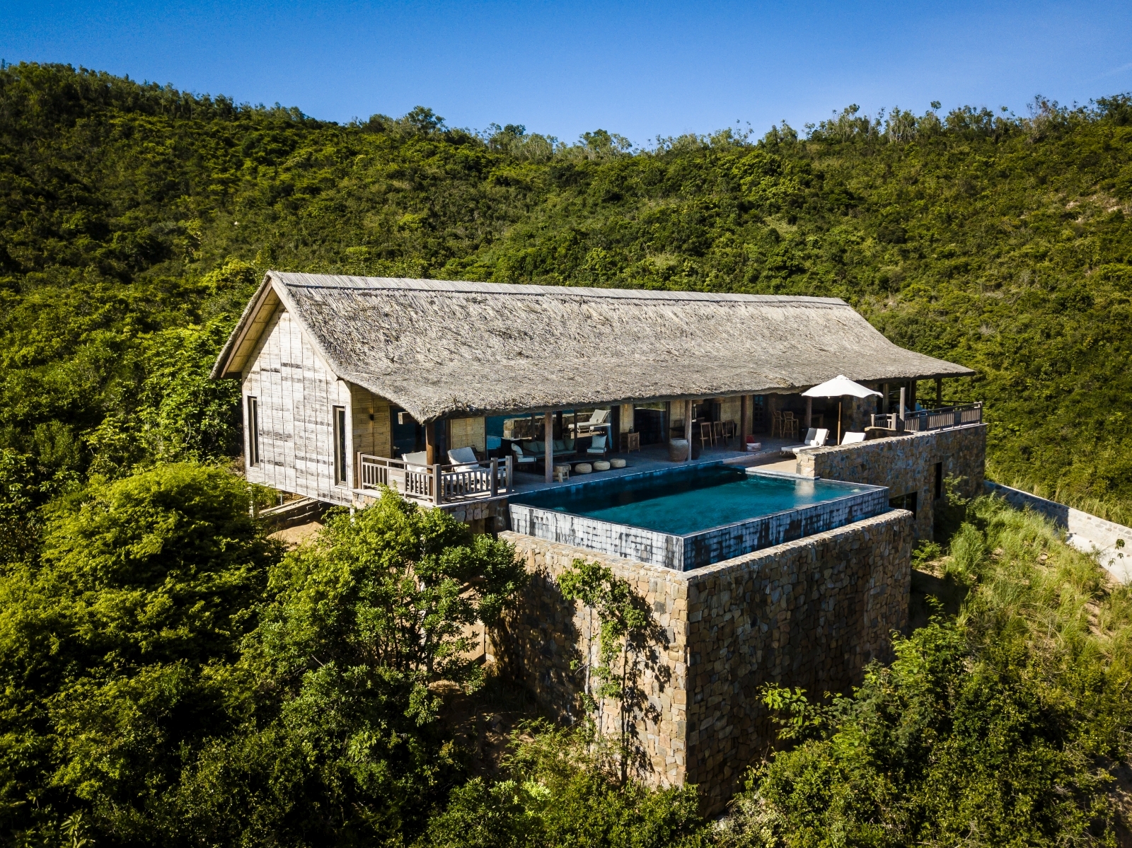 Exterior of a Grand Bay Pool Villa with private pool and plenty of shaded outdoor space at luxury resort Zannier Bai San Ho in Vietnam