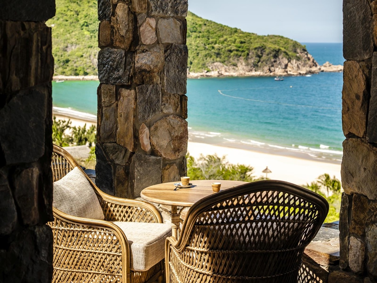 Chairs on a terrace overlooking the bay at luxury resort Zannier Bai San Ho in Vietnam