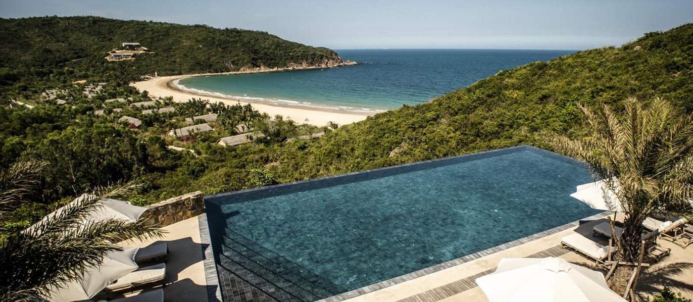 Main pool with loungers and views over the bay at luxury resort Zannier Bai San Ho in Vietnam