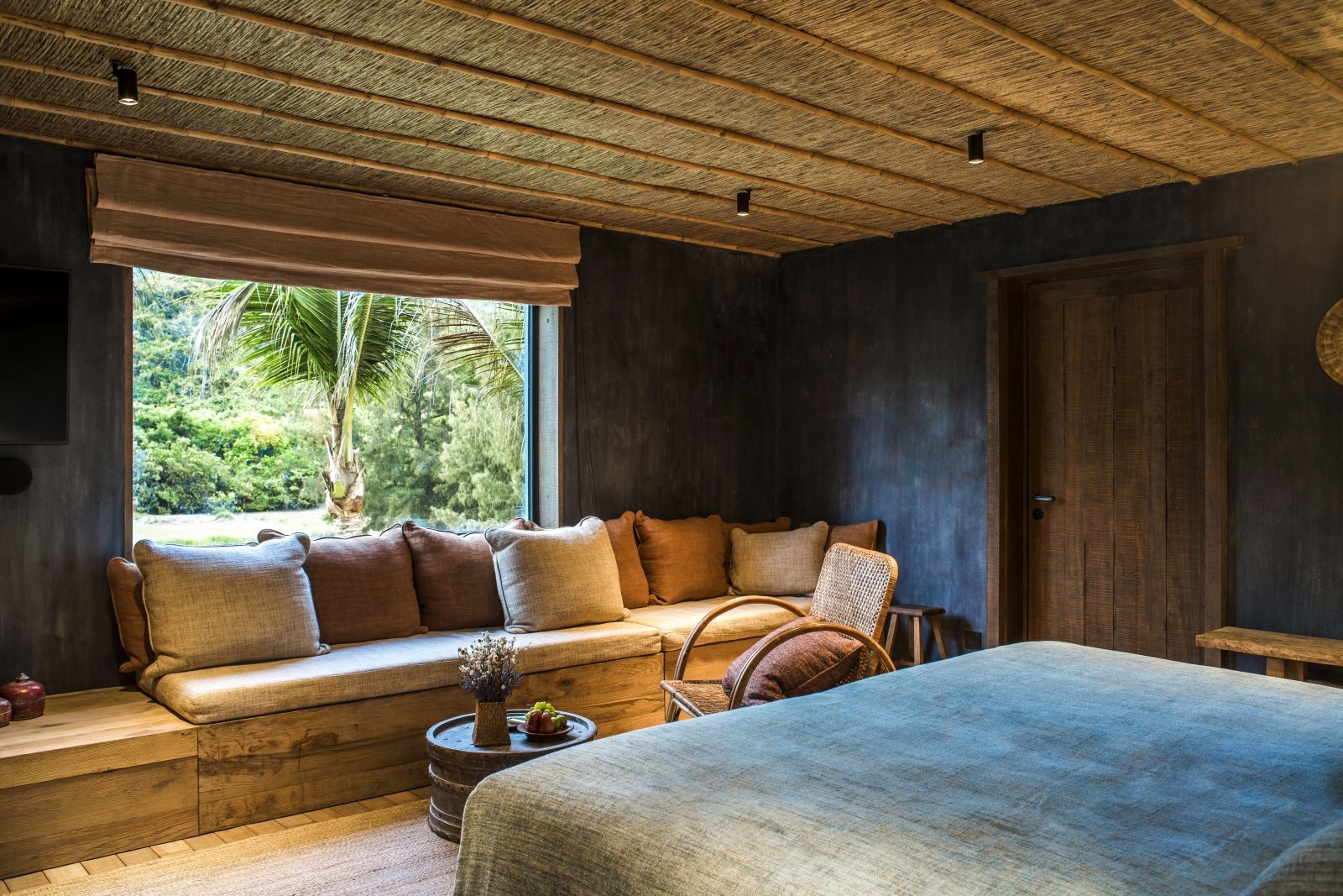 Bedroom of a Paddy Field Villa with double bed and window seating at luxury resort Zannier Bai San Ho in Vietnam