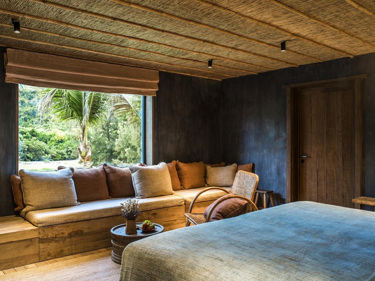 Bedroom of a Paddy Field Villa with double bed and window seating at luxury resort Zannier Bai San Ho in Vietnam