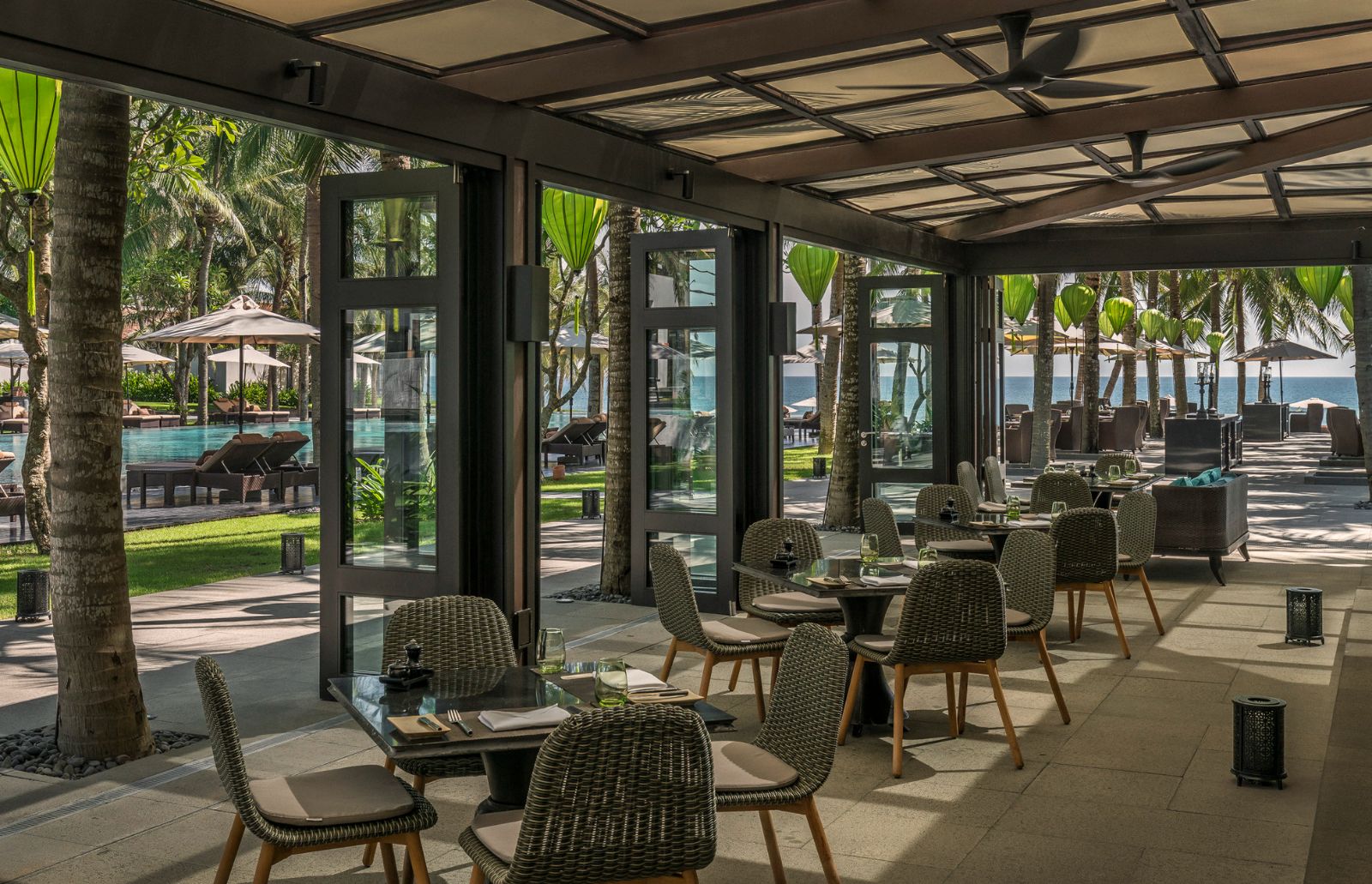 Restaurant area looking out to the main pool at luxury resort Four Seasons Nam Hai 