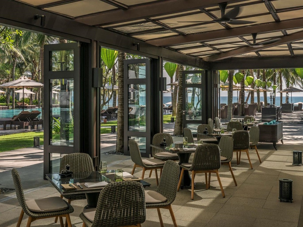 Restaurant area looking out to the main pool at luxury resort Four Seasons Nam Hai