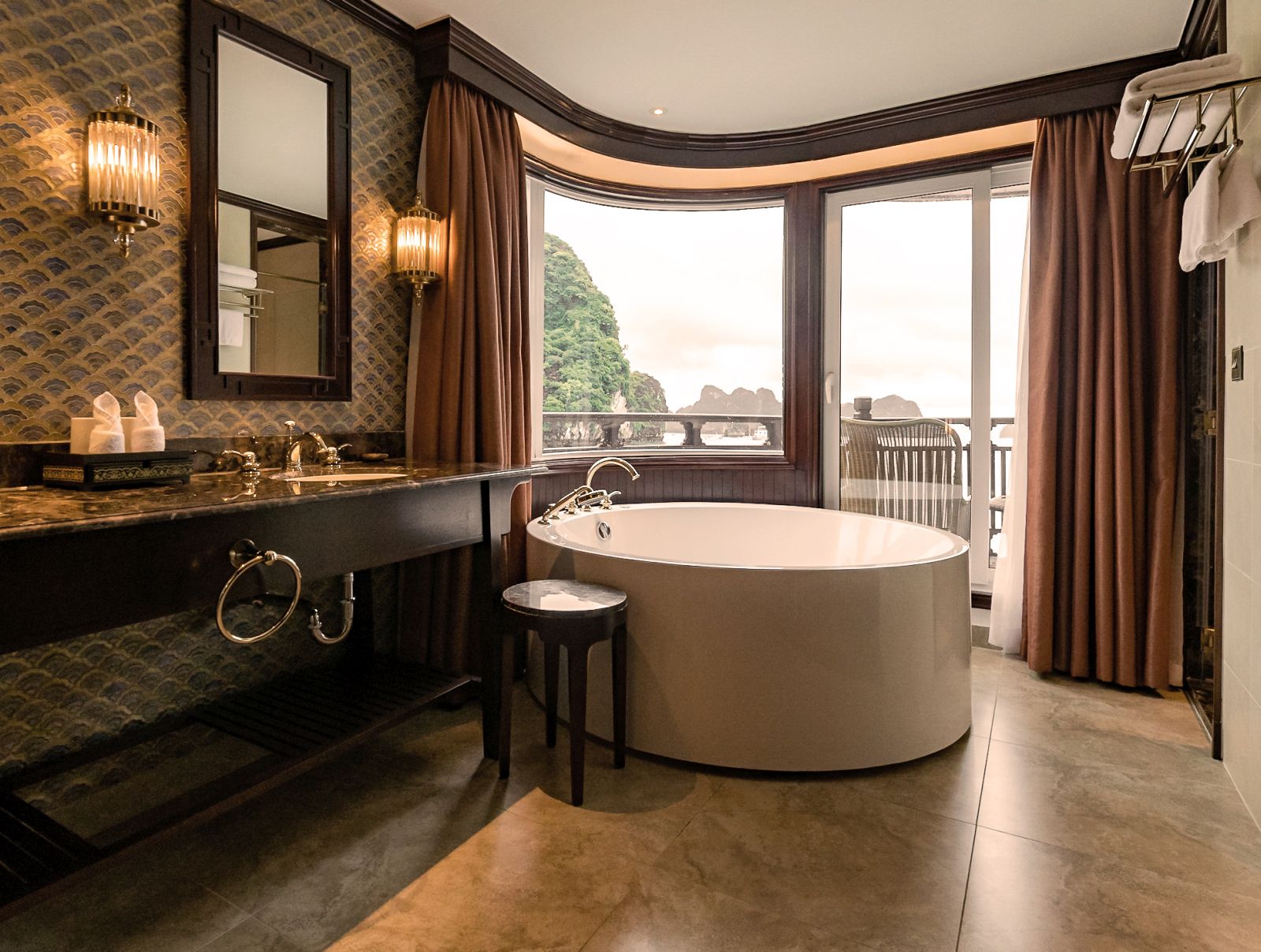 A luxury bathroom suite with a window view on the floating boutique hotel Ginger Ship cruising the Lan Ha Bay in the Gulf of Tonkin