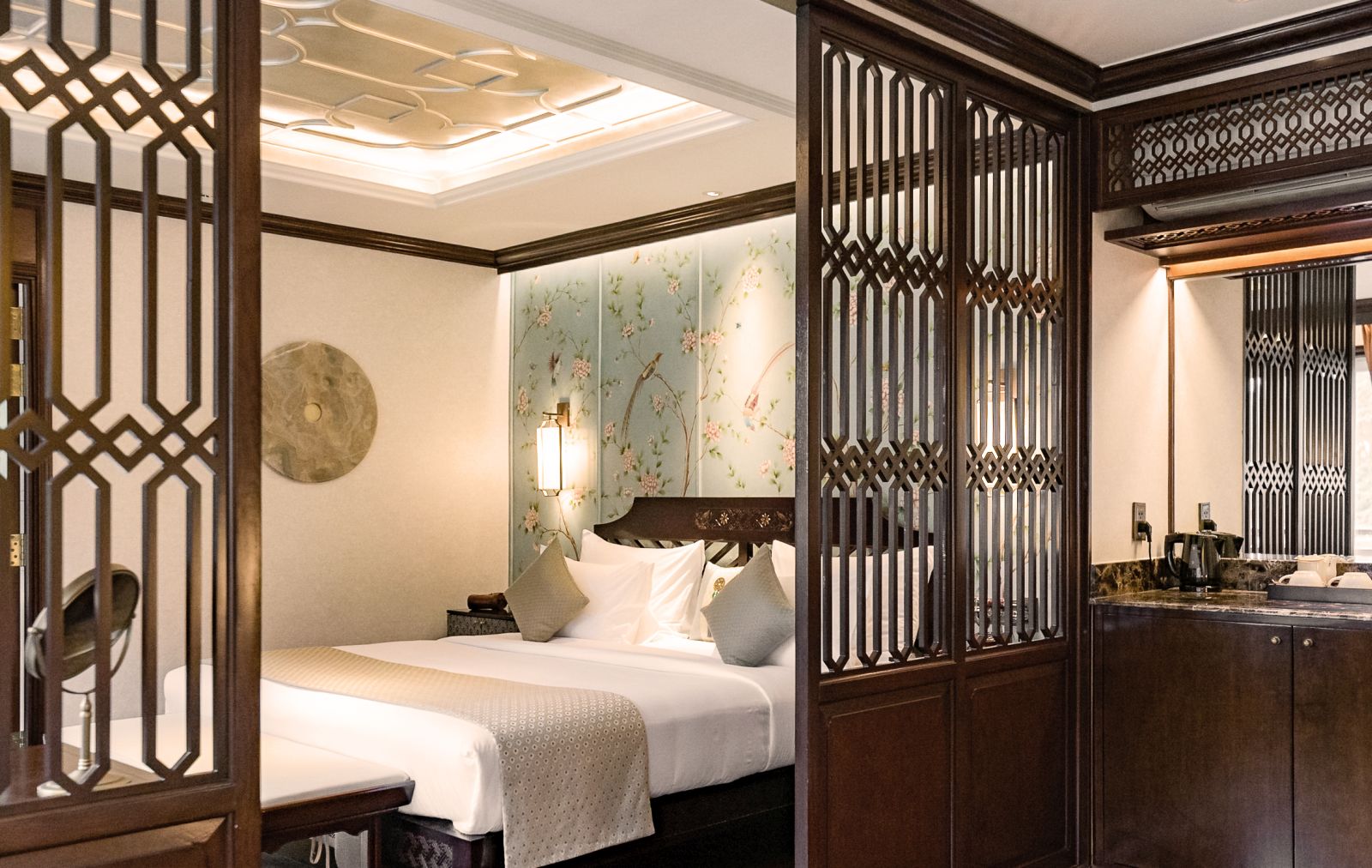 a bedroom in the Blue Phoenix suite on Ginger Ship that cruises Lan Ha Bay in the Gulf of Tonkin