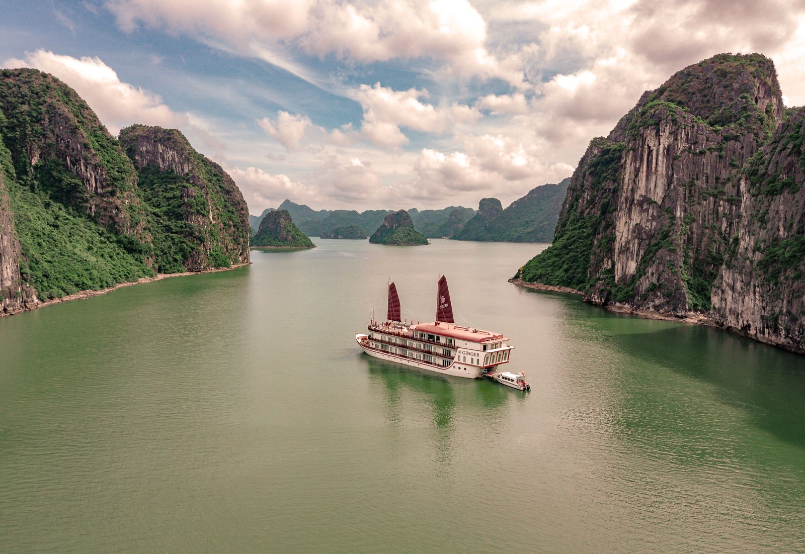 Ginger Ship, a floating boutique hotel, cruising through Lan Ha Bay in the Gulf of Tonkin