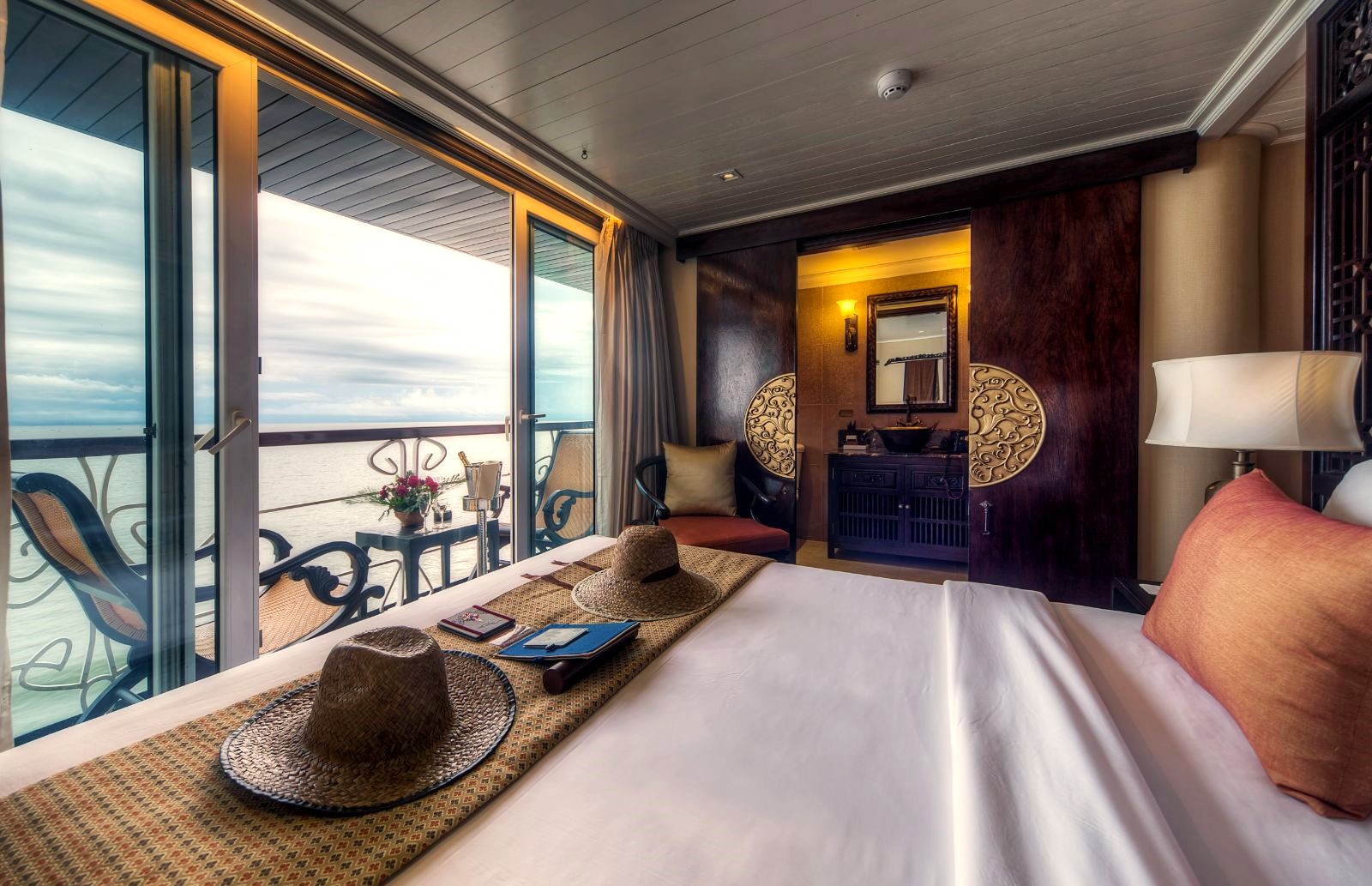 Deluxe stateroom bed onboard the Jayavarman Mekong River cruise in Vietnam