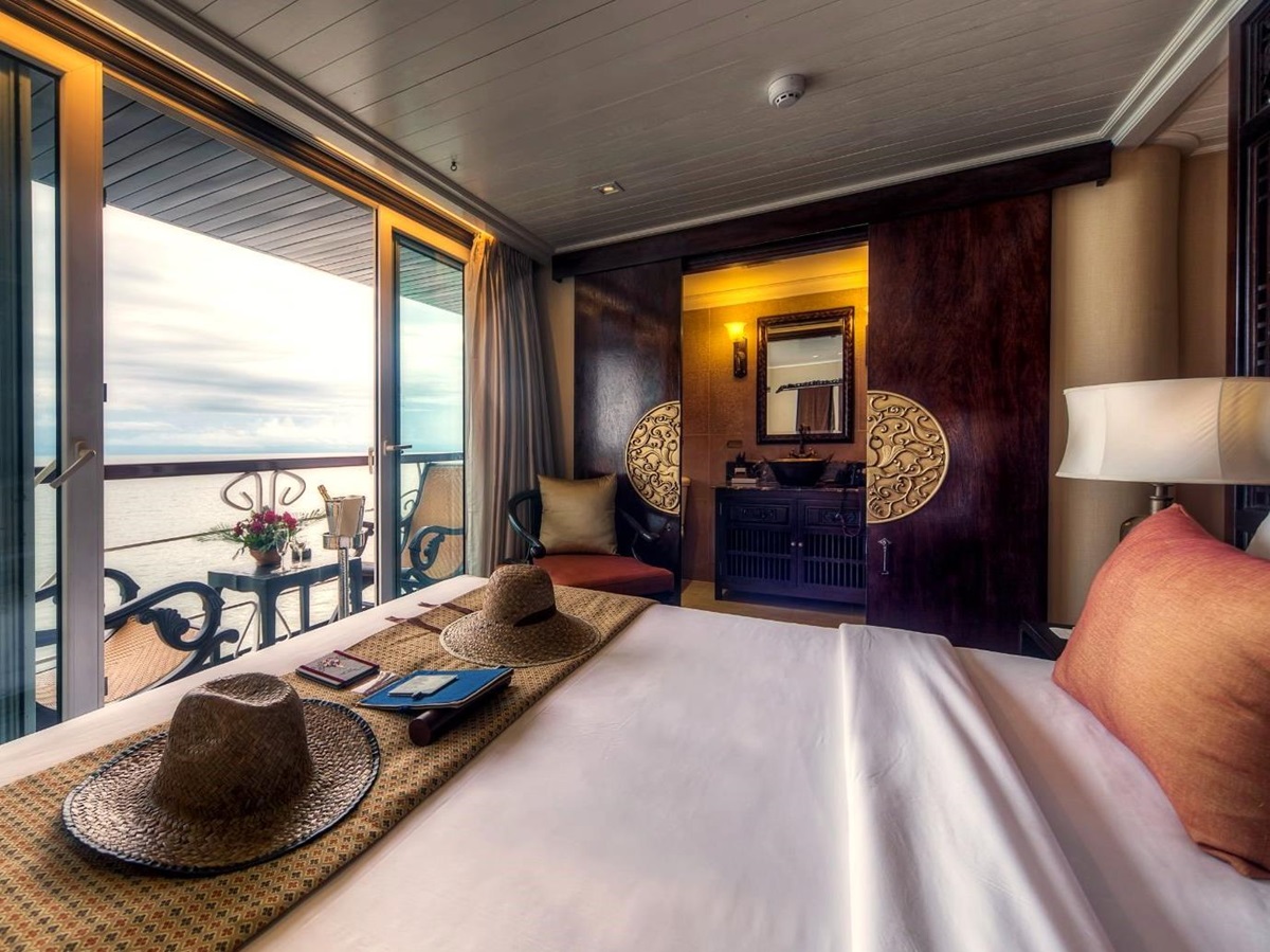 Deluxe stateroom bed onboard the Jayavarman Mekong River cruise in Vietnam