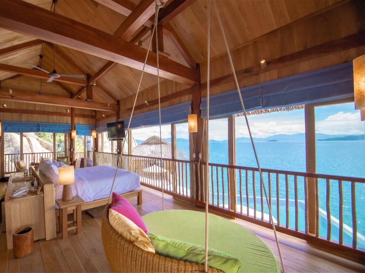 Bedroom looking out to the ocean at luxury resort Six Senses Ninh Van Bay