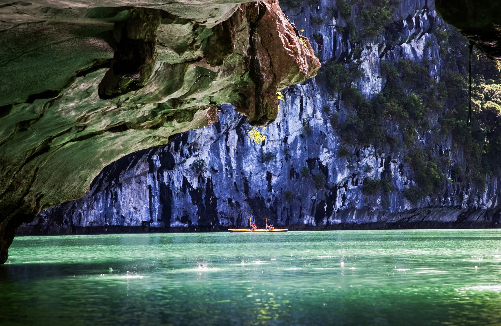Kayaking through limestone caves in Halong Bay, Vietnam