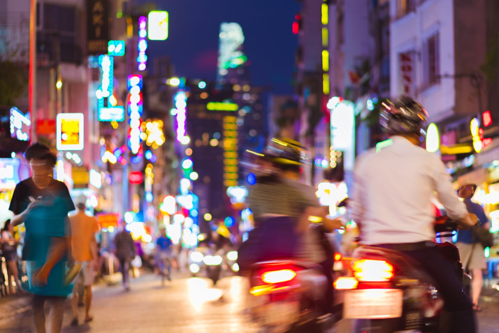 Vespas and street life in Ho Chi Minh City Vietnam at night